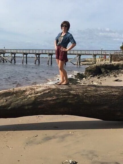 Ariel Anne standing on beach in Southport, NC